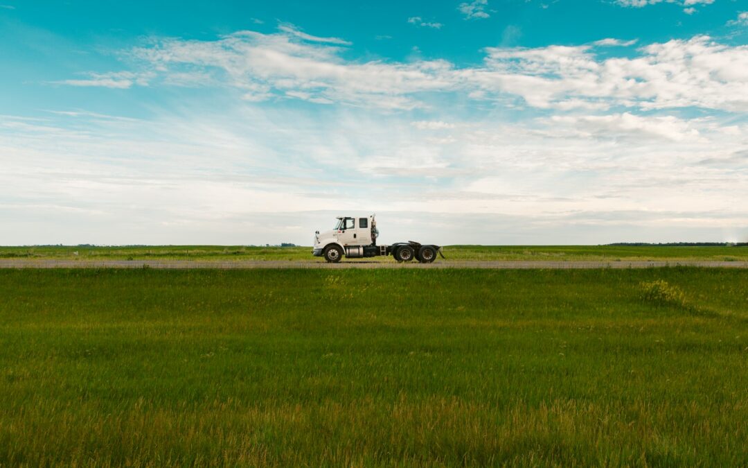 Truck driving along field